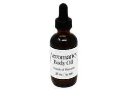 brown glass dropper bottle with white label that reads: aeromancy body oil. pomelo & plumeria. 2fl/ 59 ml