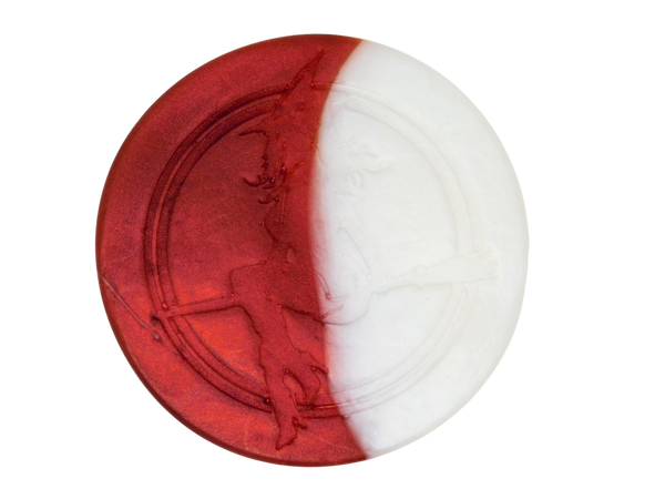 half red and white circular soap with witch baby logo engraved on top