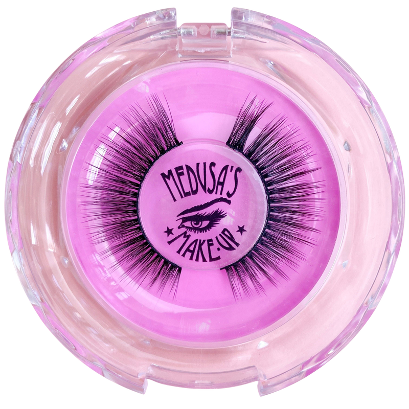 Pink container with false eyelashes branded 'Medusa's Make-Up' on a white background