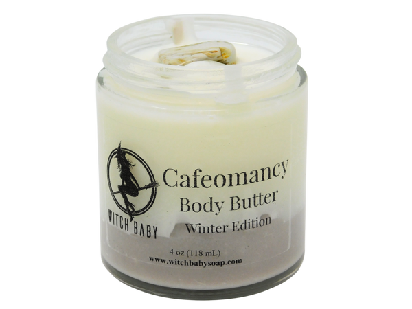 brown and white body butter topped with petrified wood in a 4 oz glass jar. Clear label reads: Cafeomancy Body Butter. Winter edition. 