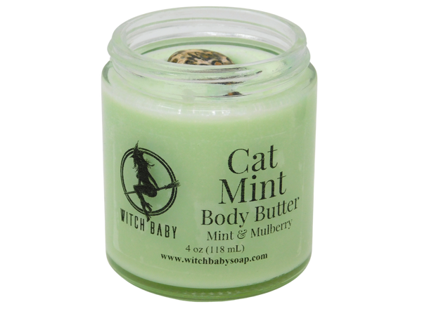 light spring green body butter in 4 oz glass jar topped with leopard skin jasper with a clear label that reads: cat mint body butter. mint & mulberry.