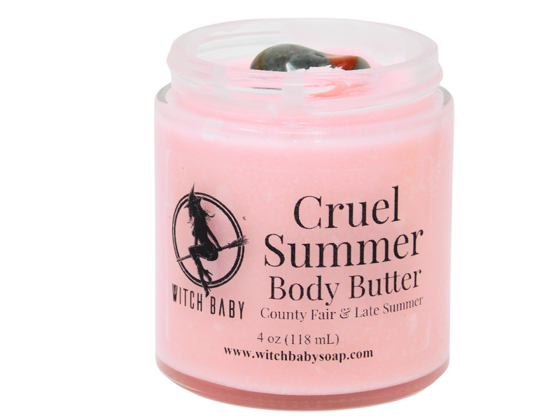 pink body butter in 4 oz glass jar with bloodstone on top and a clear label that reads: cruel summer body butter. county fair & late summer.