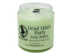 light ghoulish green body butter in 4 oz glass jar topped with black onyx. clear label reads: dead man's party body butter. spiced ale & kettle corn.