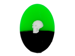 Half neon green half black oval soap with white skull embellishment on top