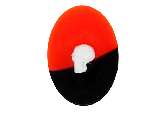 oval neon red and black soap with white skull on top