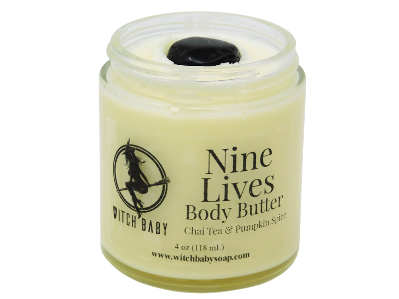 4 oz glass jar filled with lunar white body butter and topped with black onyx. Clear label reads: Nine Lives Body Butter. Chai Tea & Pumpkin Spice. 