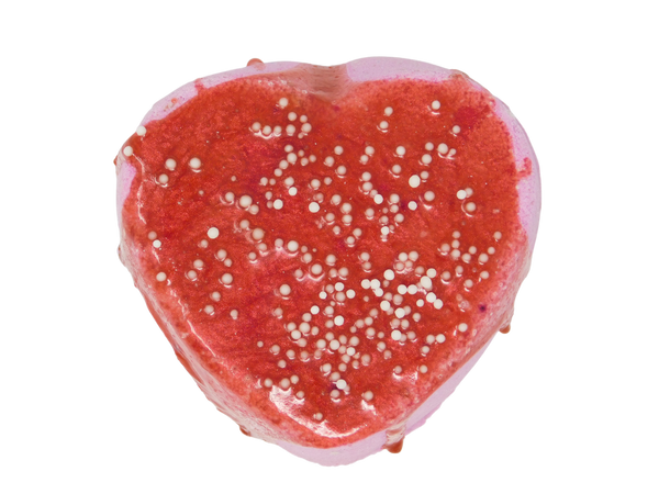 pin k heart bath bomb with red soap drizzle and white sprinkles 