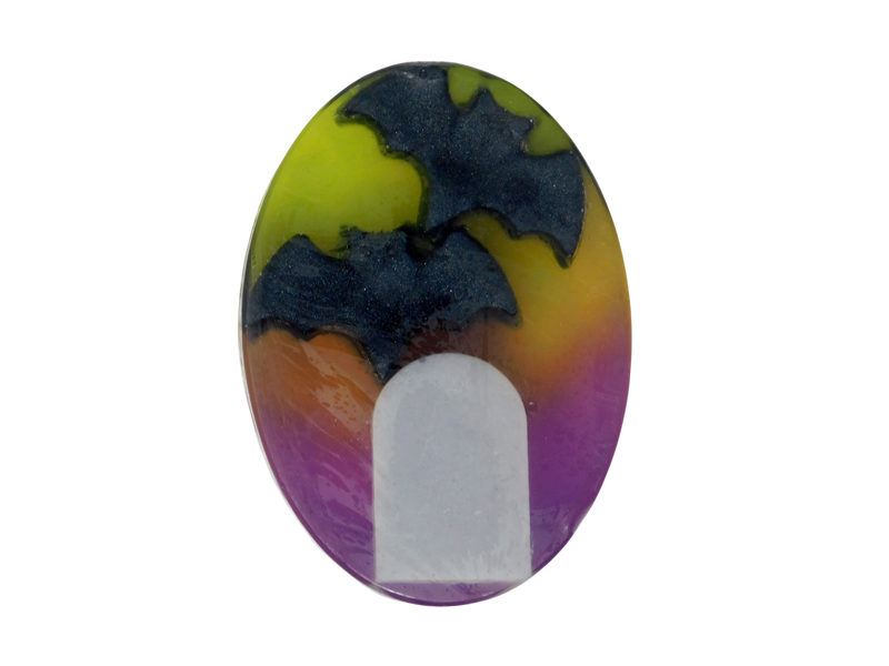 green and purple oval soap with a coffin and two bats