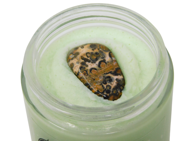 close up of leopard skin jasper on top of cat mint body butter
