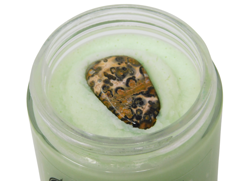 close up of leopard skin jasper on top of cat mint body butter
