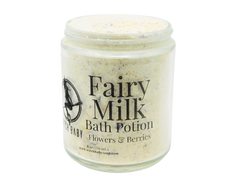 white powdery bath potion full of flowers and salt in an 8 oz glass jar with a label that reads: Fairy Milk Bath Potion. Berries - Flowers - Vanilla..