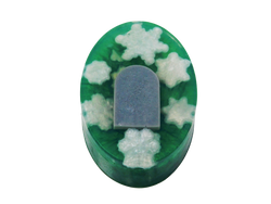 green oval soap with white snowflakes and a grey tombstone embedded inside 