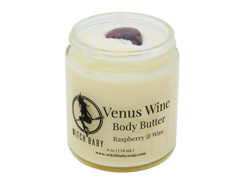 4 oz glass jar filled with white body butter and topped with rhodonite. Clear label reads Venus Wine Body Butter. Raspberry & Wine.